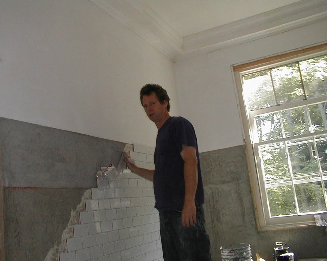 Carter laying subway tile in bathroom or kitchen